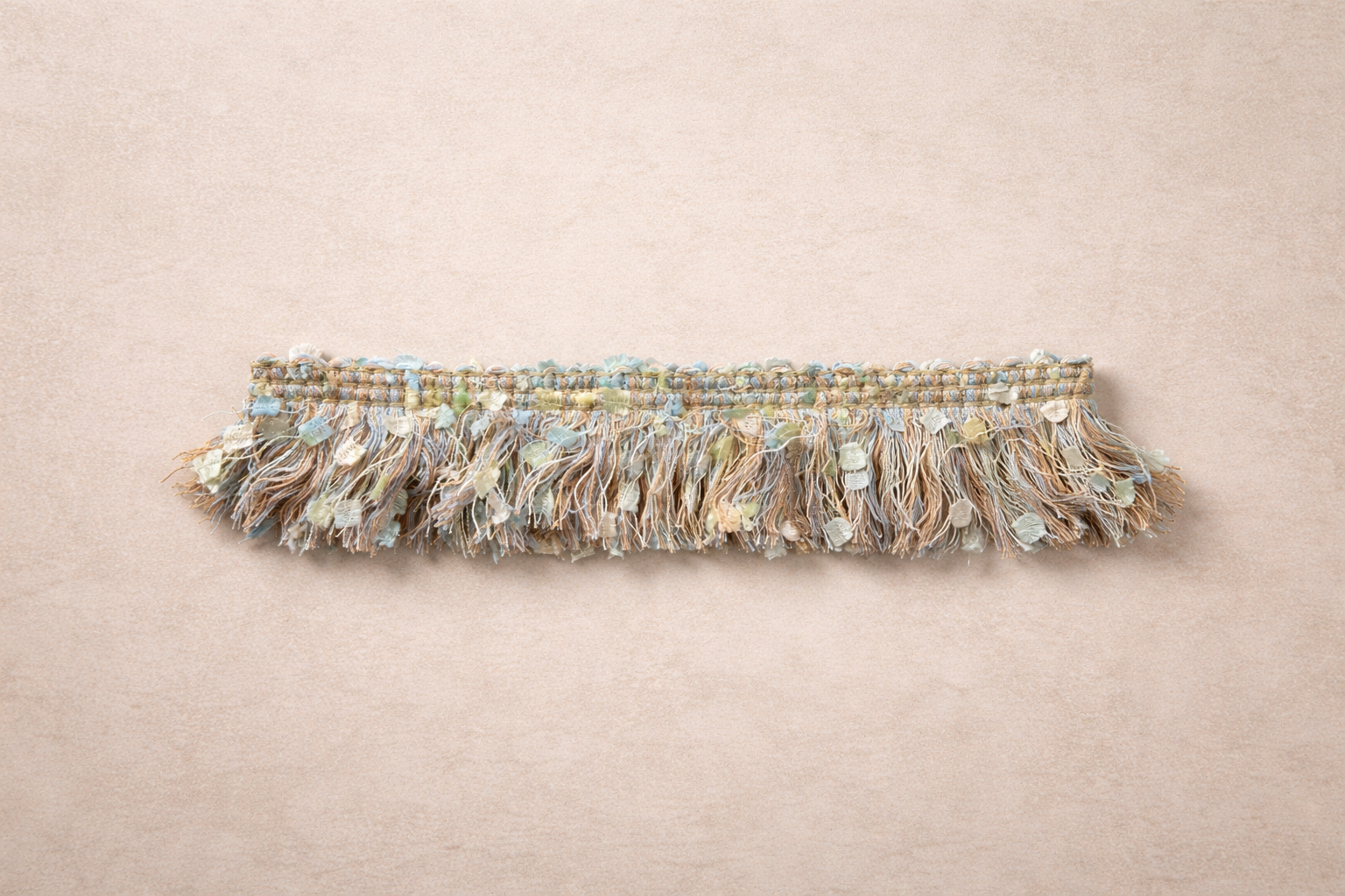 Pastel Fleck Fringe Tissue Box Cover in powder blue, pale yellow, and soft peach tones with subtle flecked ribbon texture.