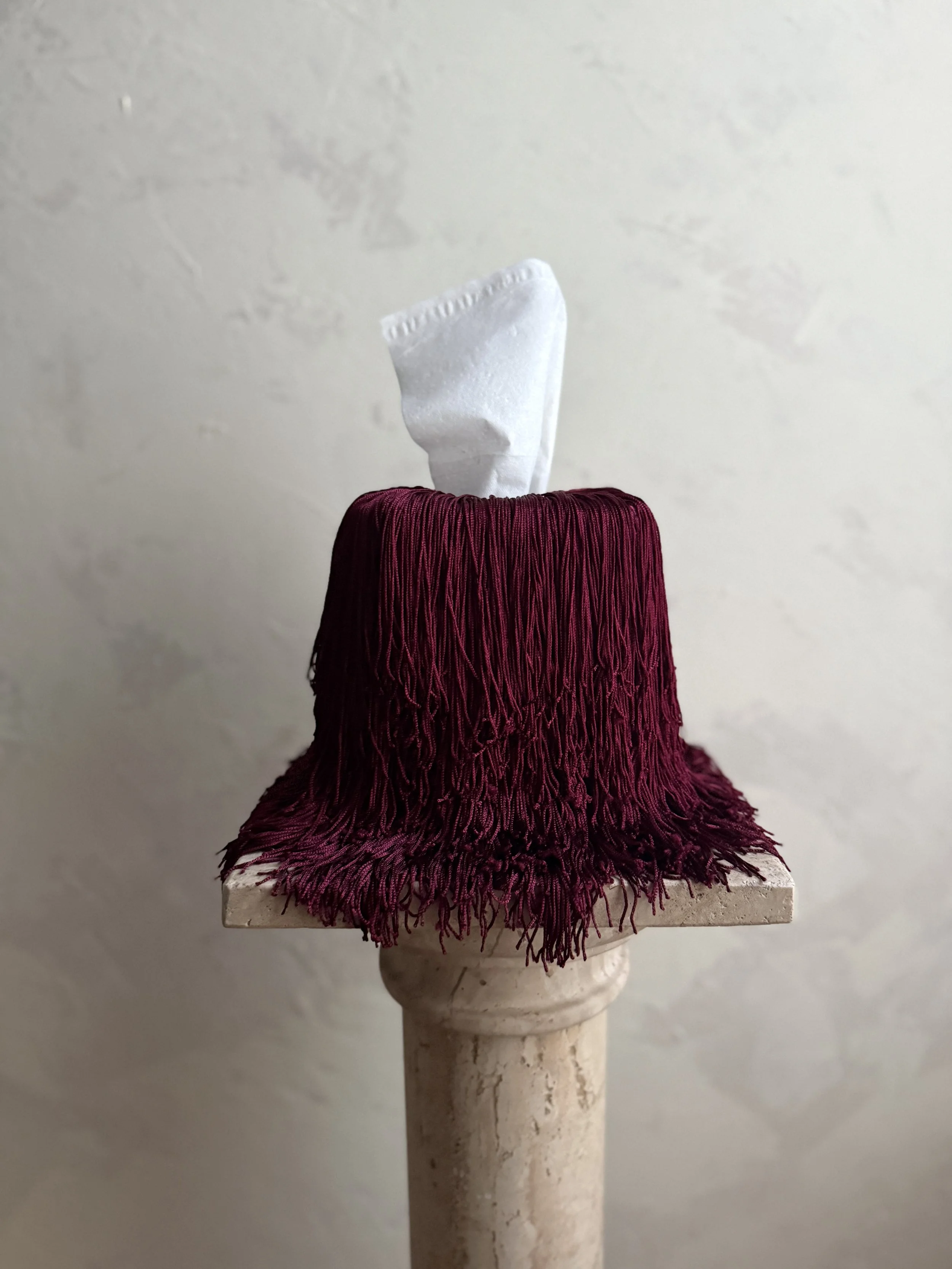 Deep Burgundy fringe tissue box cover draping elegantly with long fringe from the Spill Edit by Amber Renee Hansen.