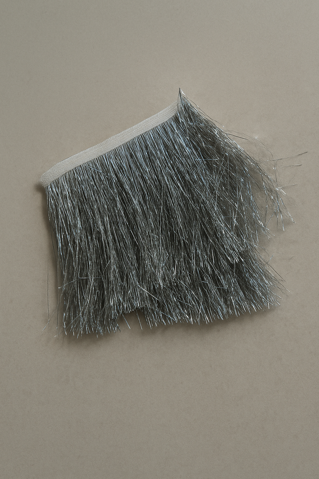 Silv er tinsel fringe tissue box cover styled as a sculptural architectural object
