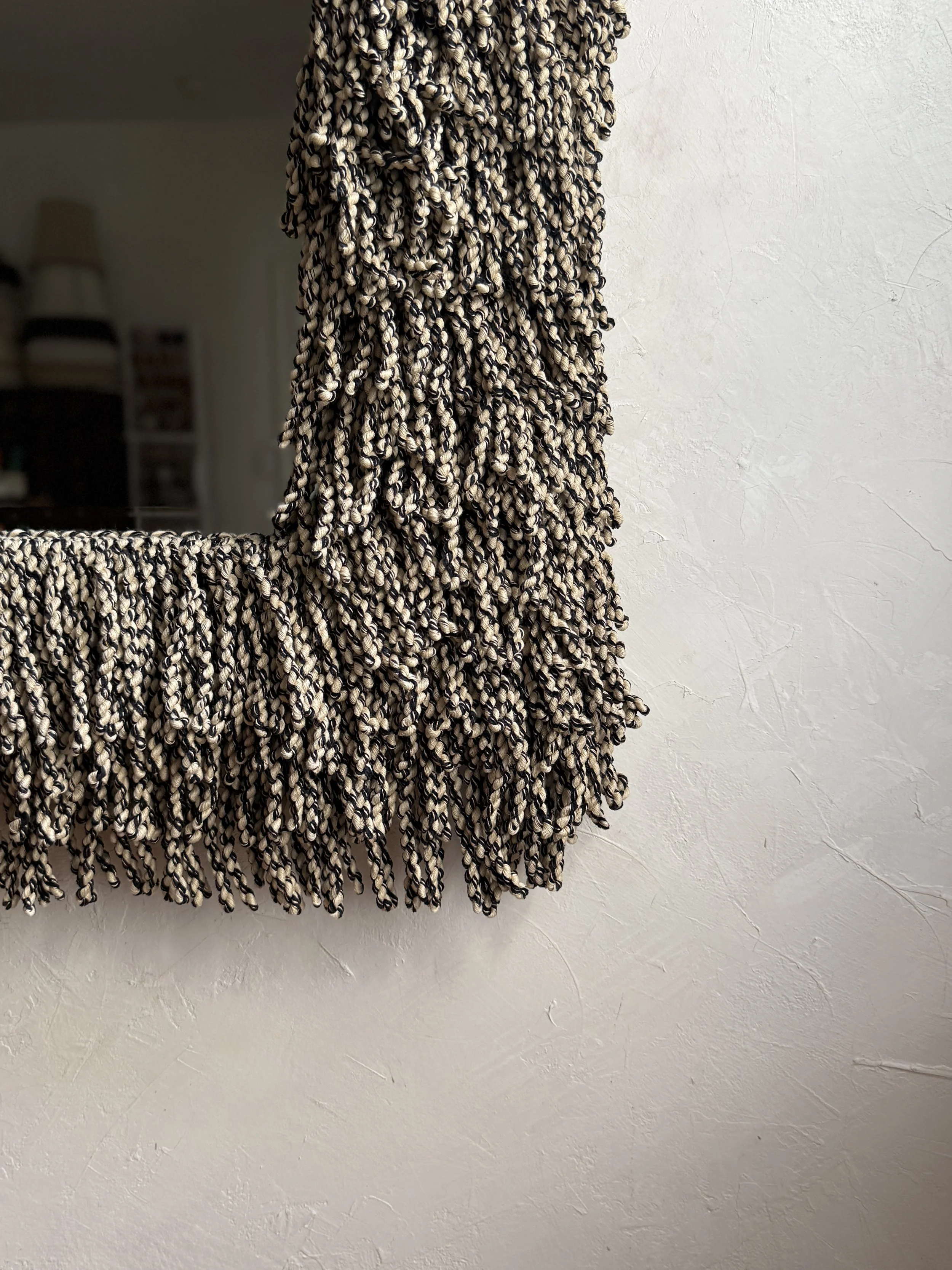Side view showing depth and layered texture of the Oat Milk & Char Fringe Mirror fringe frame.