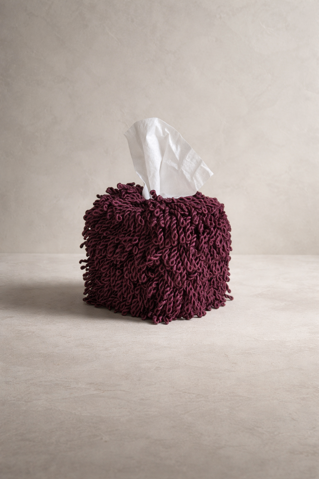 Wild Aubergine fringe tissue box cover featuring dense twisted fringe in a deep red-based aubergine with subtle sheen against a warm neutral background.
