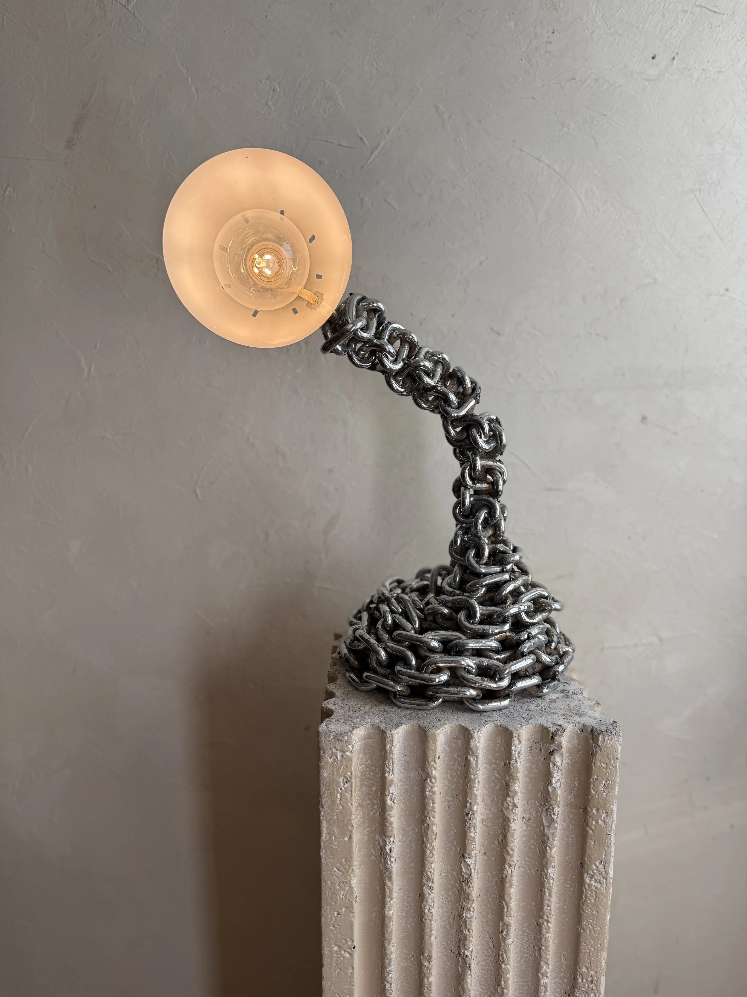 Chain table lamp with fringe shade in warm, textural glow