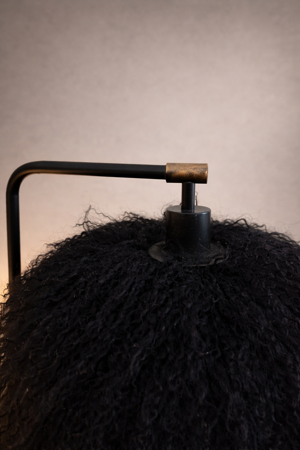 Close-up of black Mongolian lamb sheepskin texture on table lamp shade