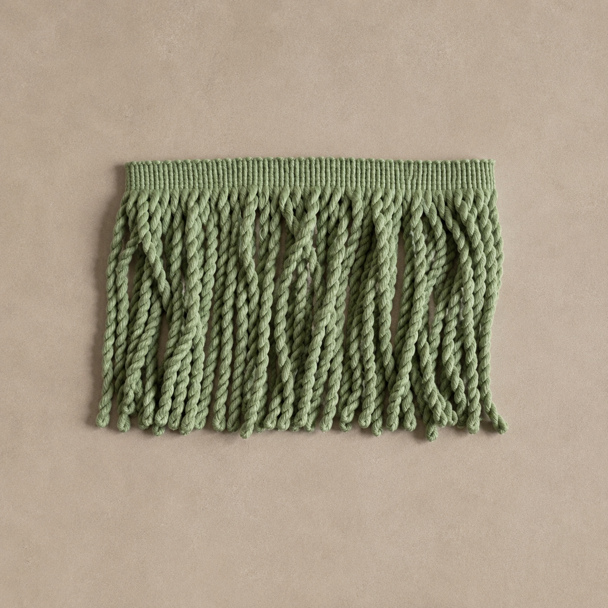 Close-up of soft pistachio bullion fringe, highlighting the delicate texture and craftsmanship of the material.
