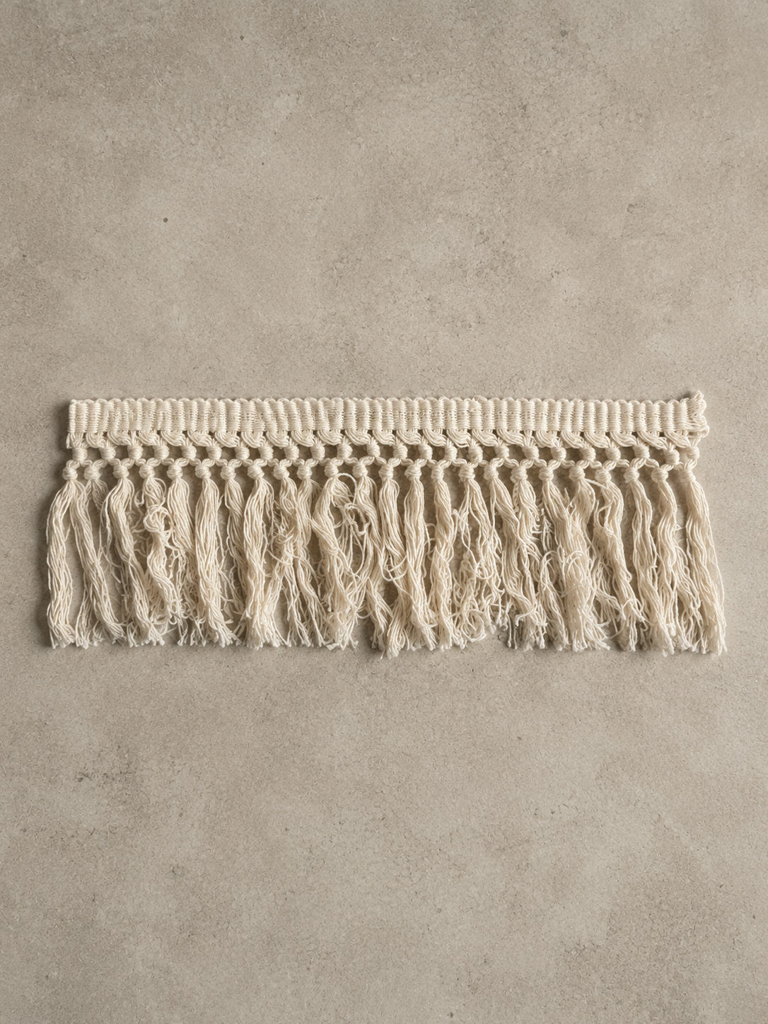 Sculptural tissue box cover featuring soft Undone Muslin cotton fringe and a cube silhouette.