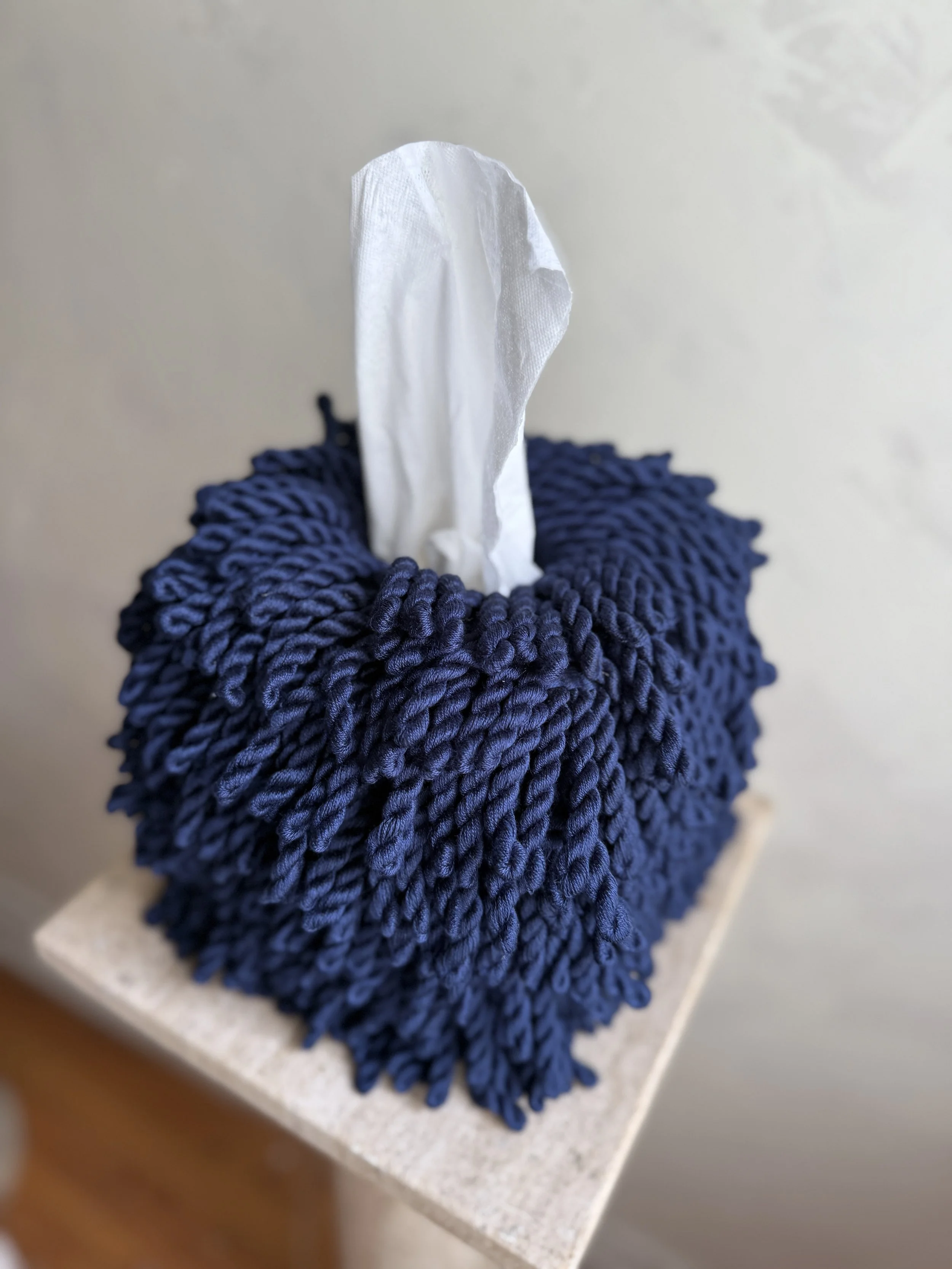 Midnight Blue Fringe Tissue Box Cover with hand-twisted fringe detailing on pedestal, designed by Amber Renee Hansen.