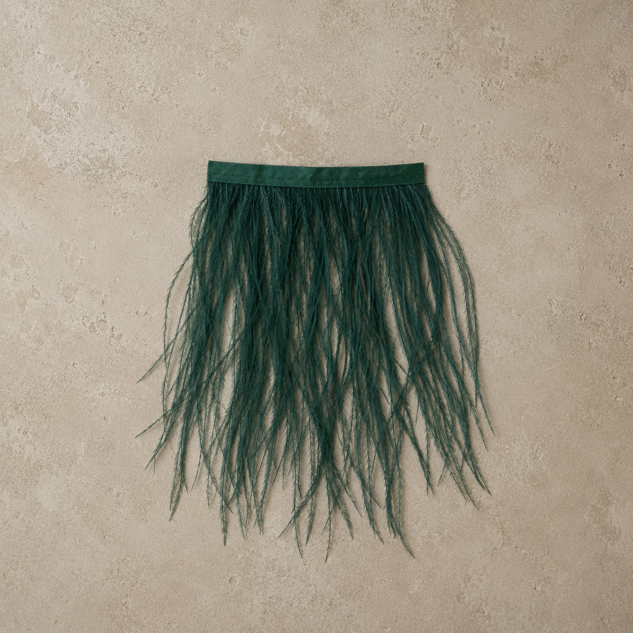 Viridian ostrich feather tissue box cover handcrafted with genuine green ostrich feathers in a minimalist editorial setting.