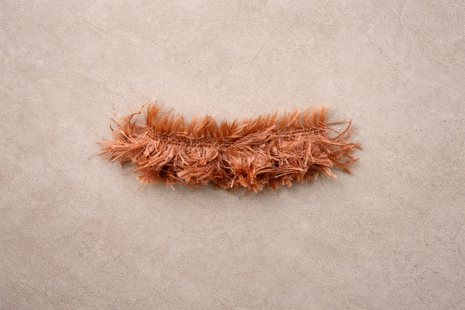Guava Teddy fringe tissue box cover with plush textured fringe and subtle sheen photographed in a minimal editorial studio setting