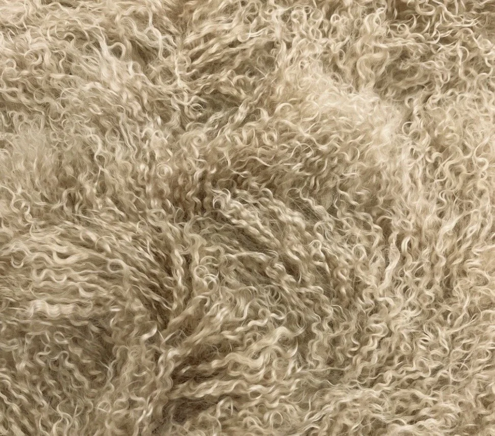 Wing Span Mongolian Lamb Bench in Soft Oat, featuring a dark espresso metal crossed frame, photographed in a quiet neutral setting