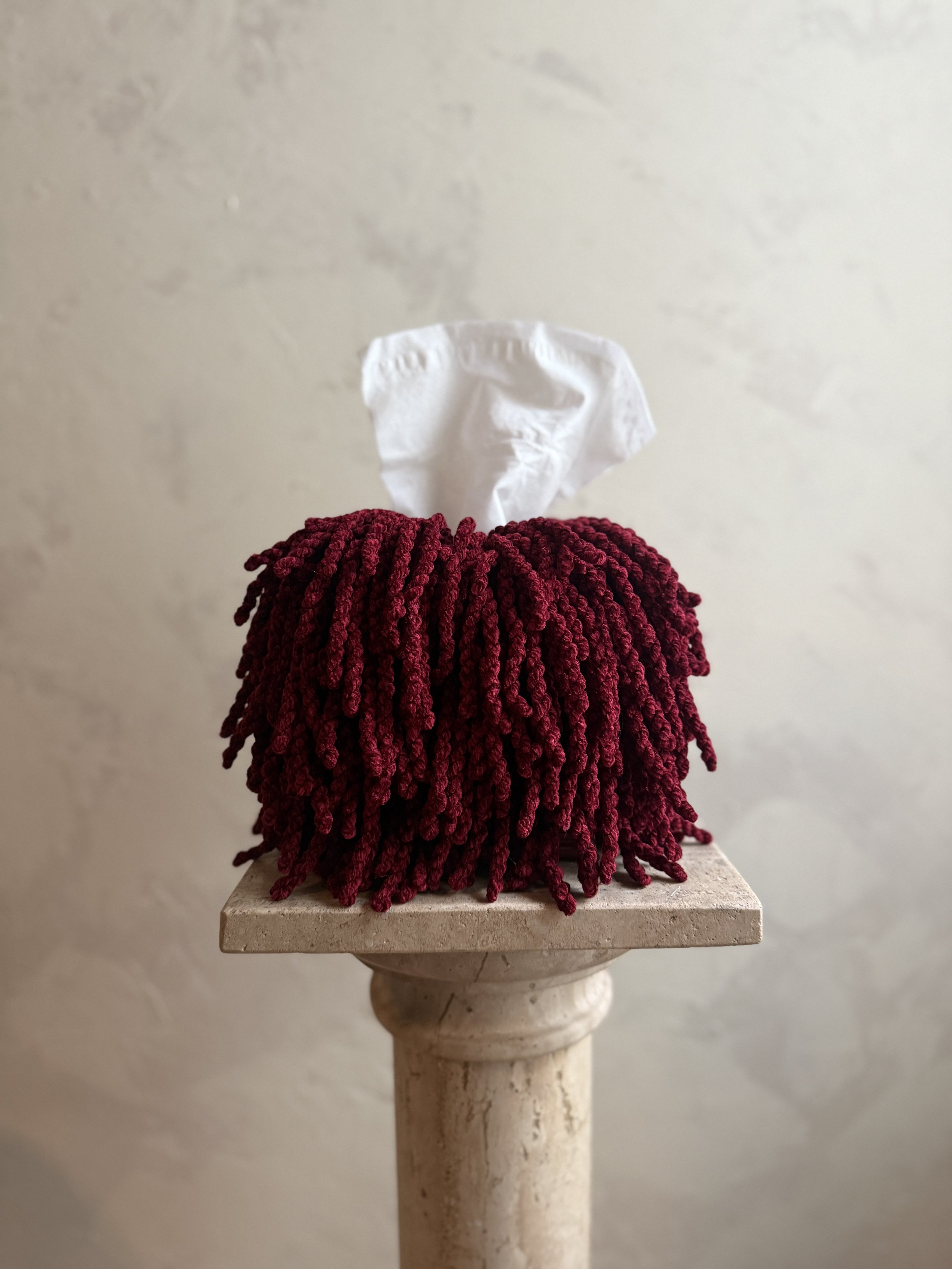 Textured oxblood fringe tissue box cover close-up