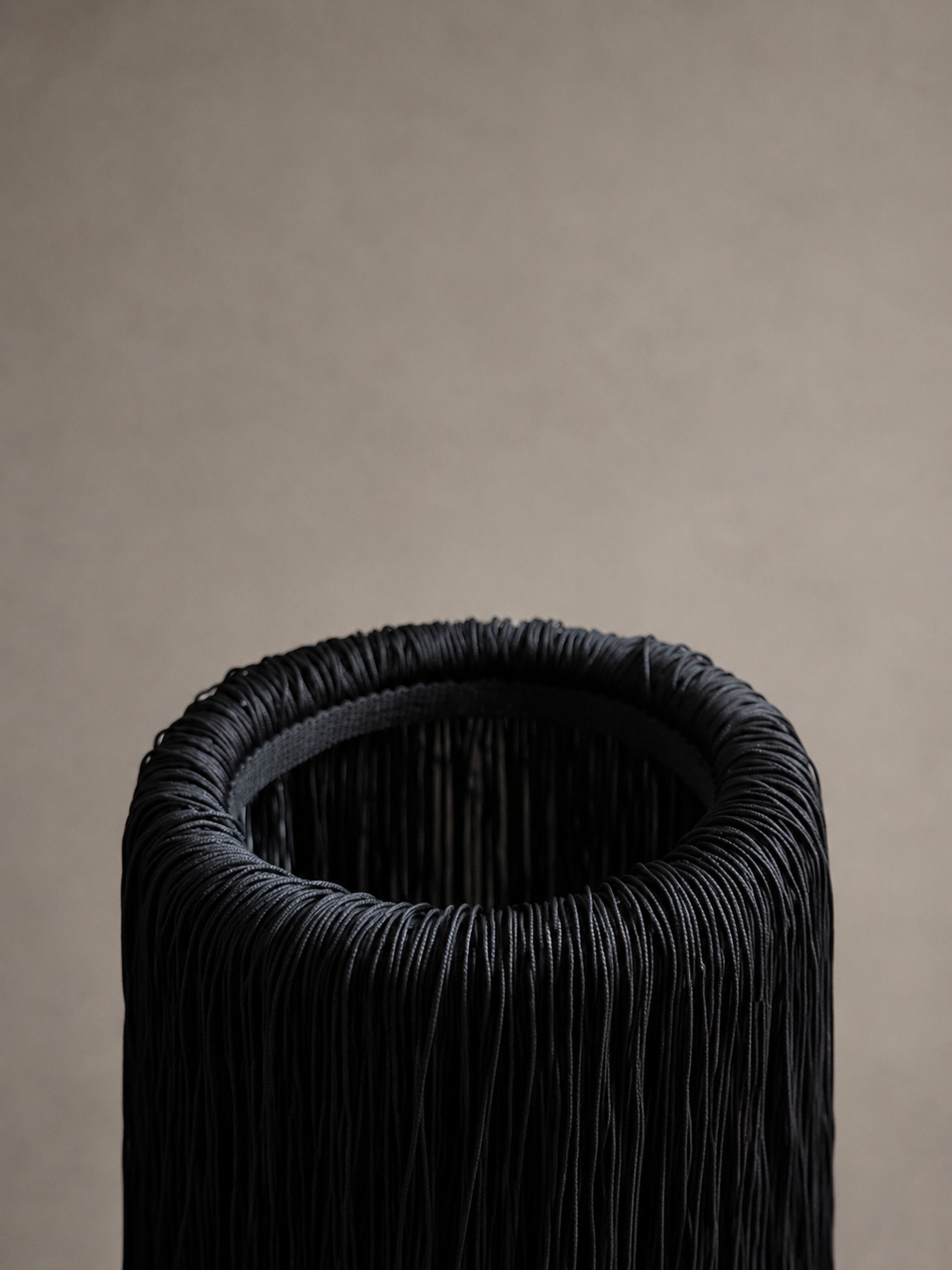Close-up detail of the fringe, draping down the rim of the marble chiller, highlighting the texture and hand-finished craftsmanship.