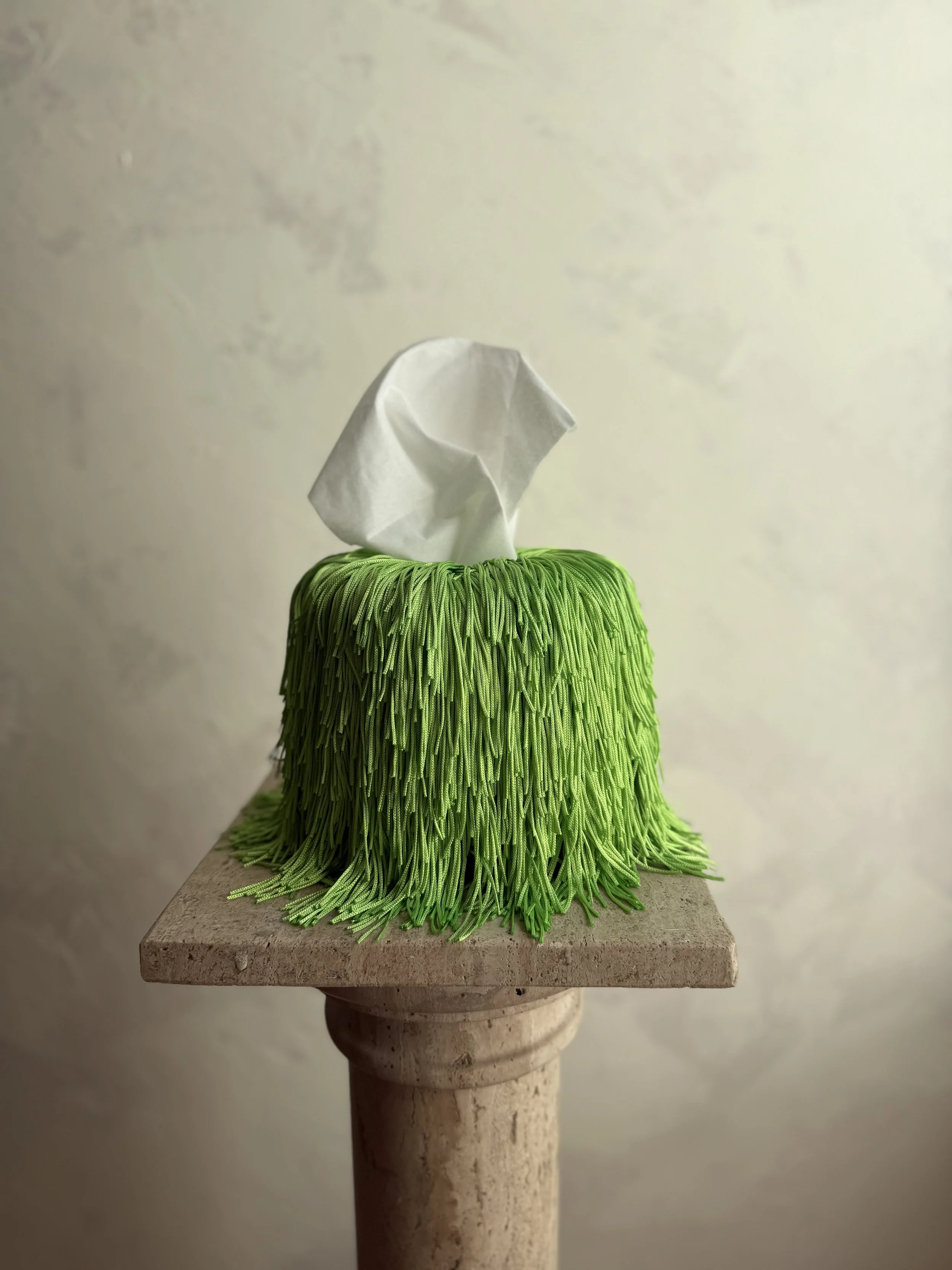 Soft Electric Green Fringe Tissue Box Cover — Spill Edit with round-form ceramic base and hand-wrapped layered fringe, designed by Amber Renee Hansen.