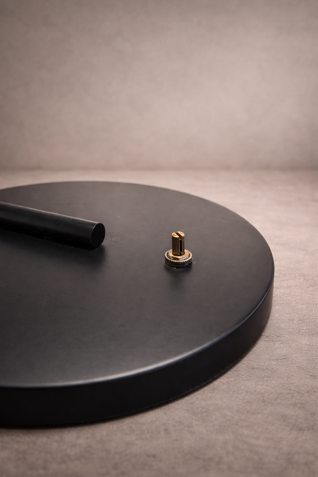 Detail of black Mongolian lamb shade layered over glass inner shade on matte black table lamp