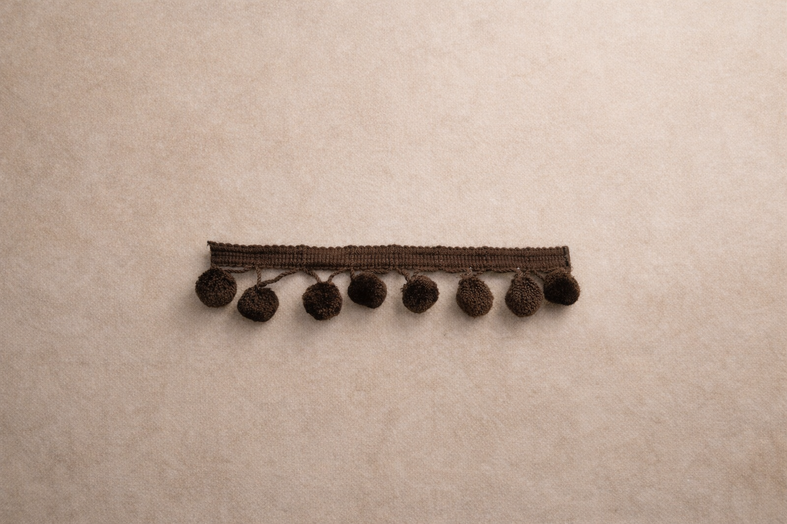 Cocoa Pom tissue box cover with rounded trim detail in warm brown.