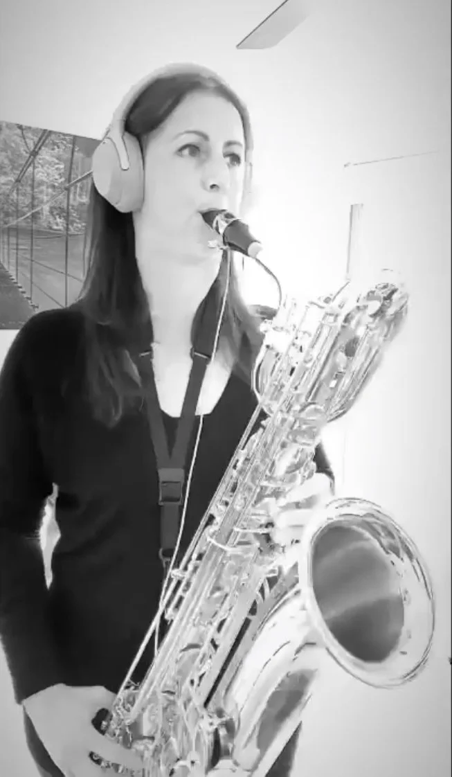 Miss Jo Carey playing Baritone Saxophone whilst recording
