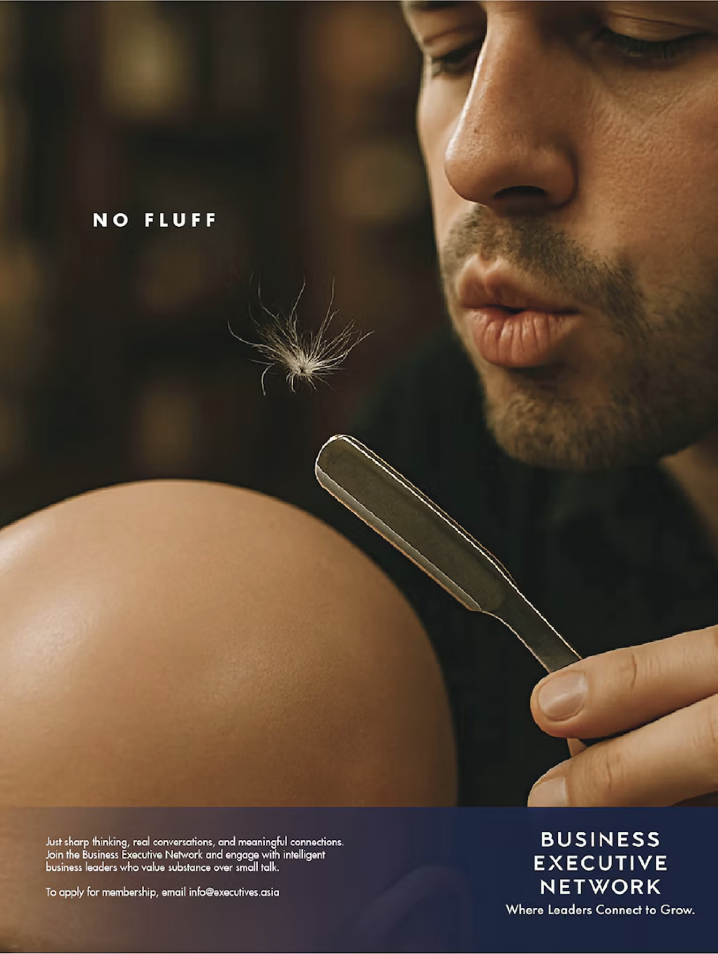 Close-up of a man with a beard and mustache holding a straight razor near his face, with a dandelion seed floating in the foreground. The background is blurred.