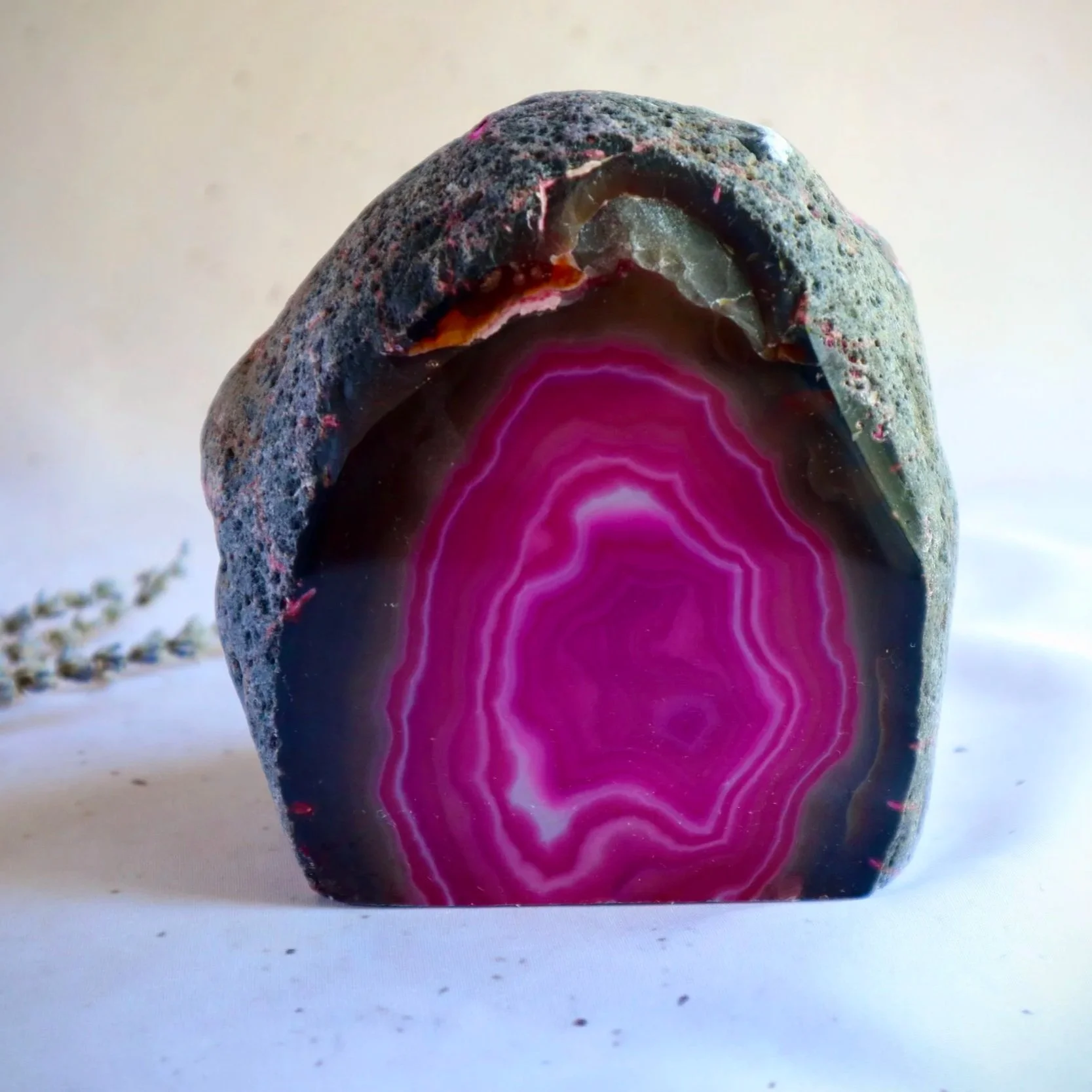 Exact Pink Dyed Agate candle holder with vibrant natural banding and rough outer edge.