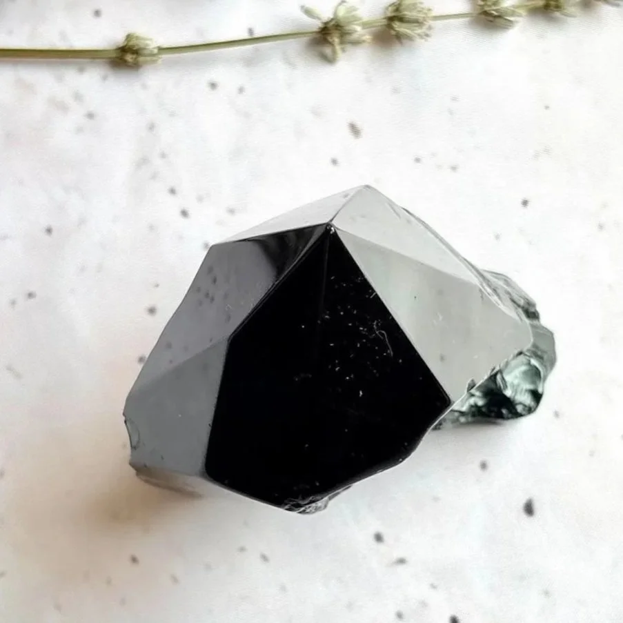 Black Obsidian polished point associated with grounding and protection