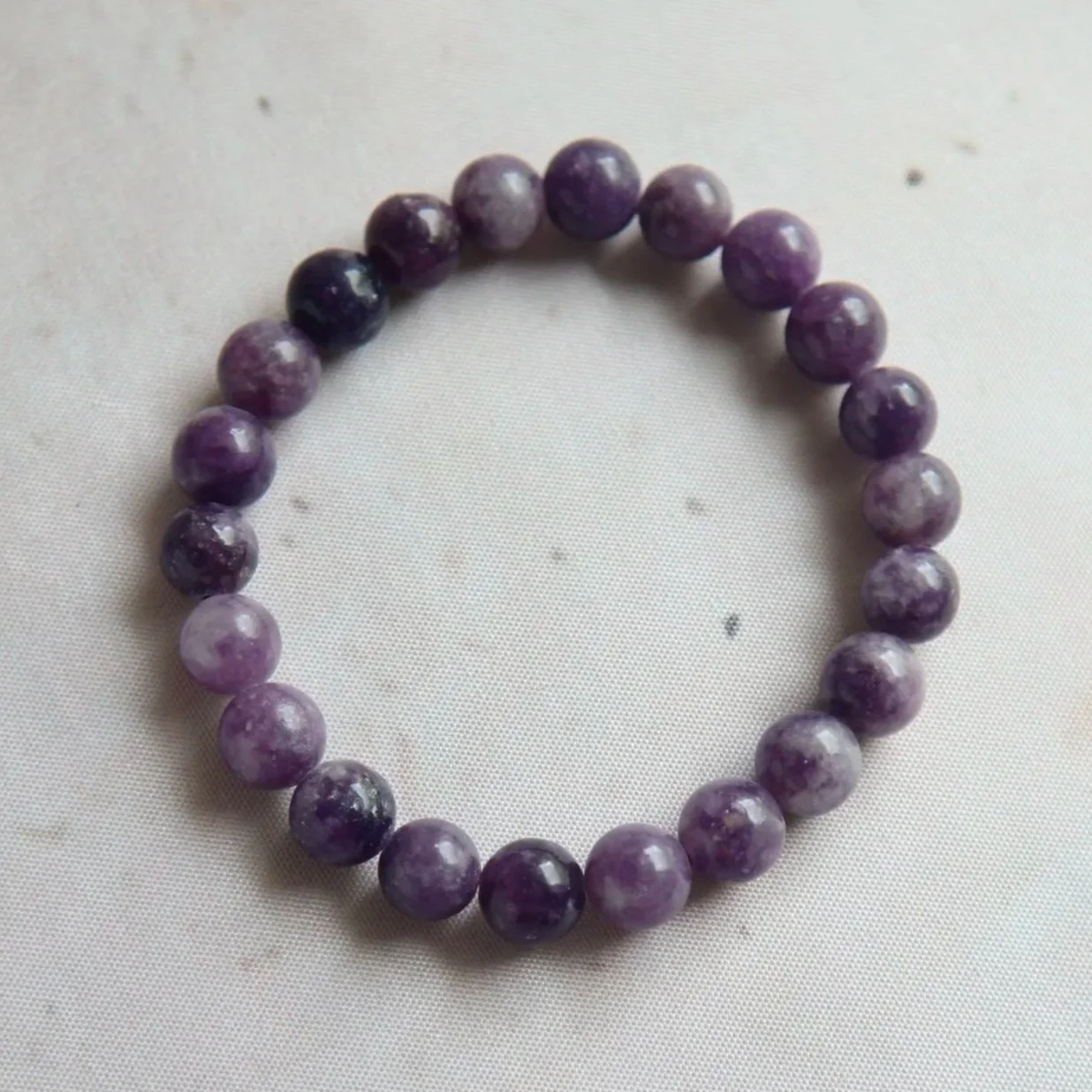 Lepidolite 8mm round bead bracelet in soft purple and lilac tones.