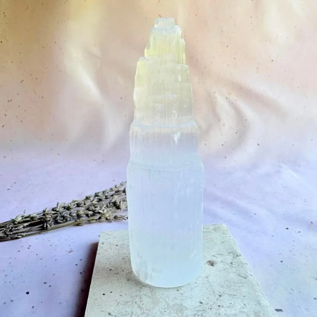 Natural white Satin Spar tower displaying rough layered crystal formations