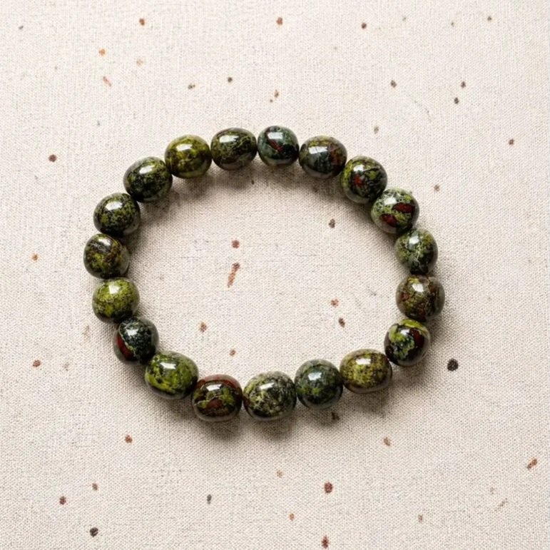 Kambaba Jasper crystal bracelet with polished tumble beads displaying distinctive green swirls and natural dark patterns.