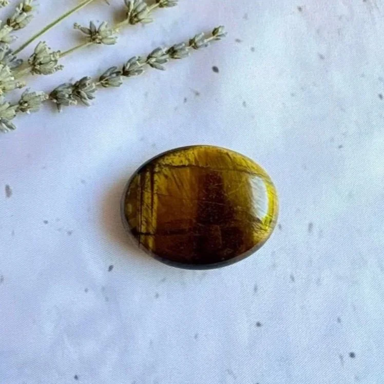 Natural Tiger's Eye palm stone measuring approximately 5cm with golden brown banding