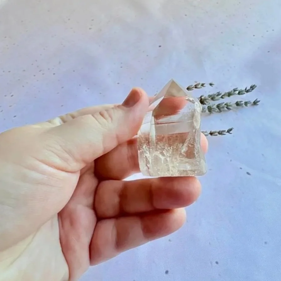 Natural Clear Quartz crystal tower featuring a polished surface and natural rough section