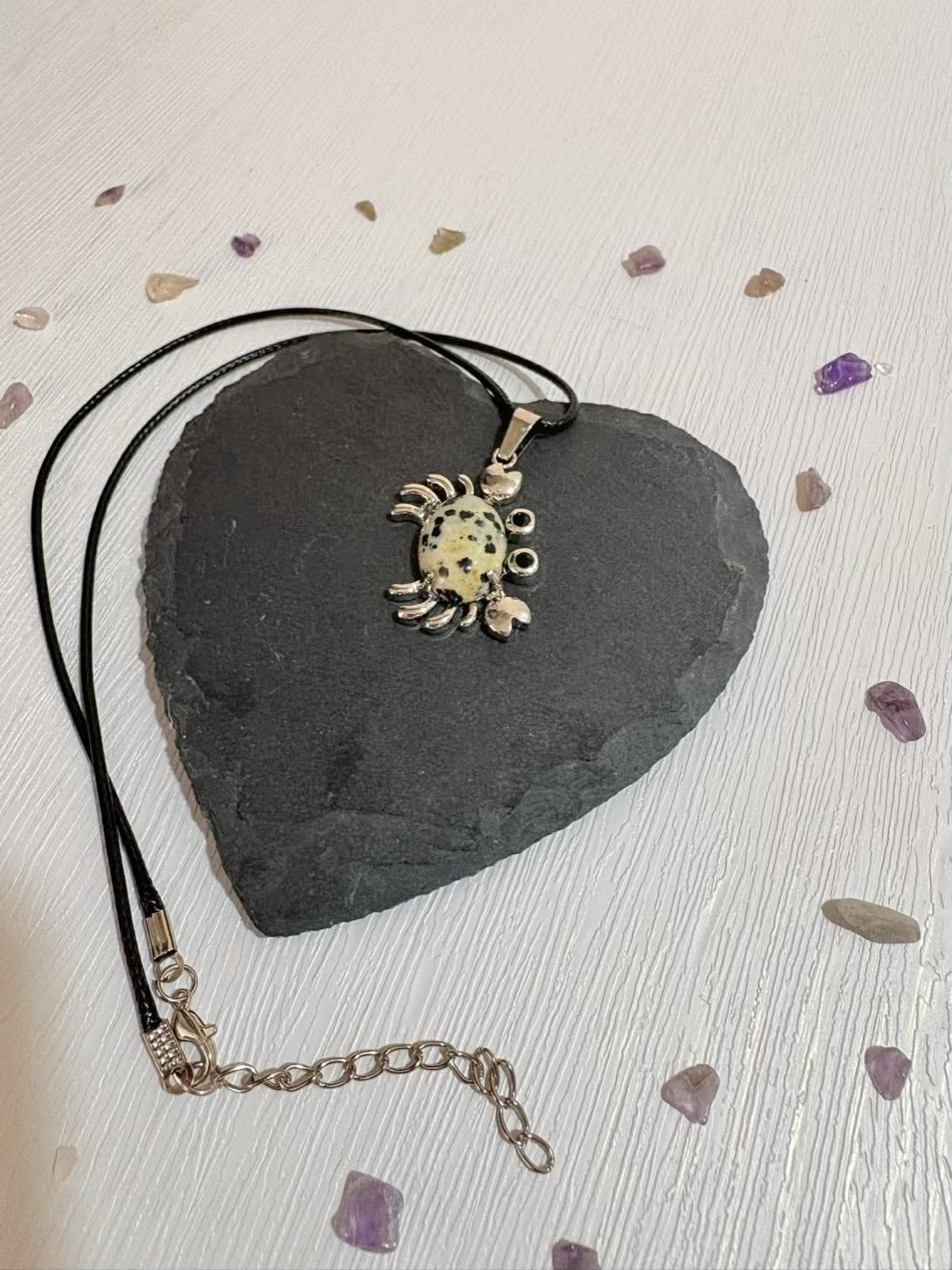 Dalmatian Jasper crab pendant close up showing black spotted pattern
