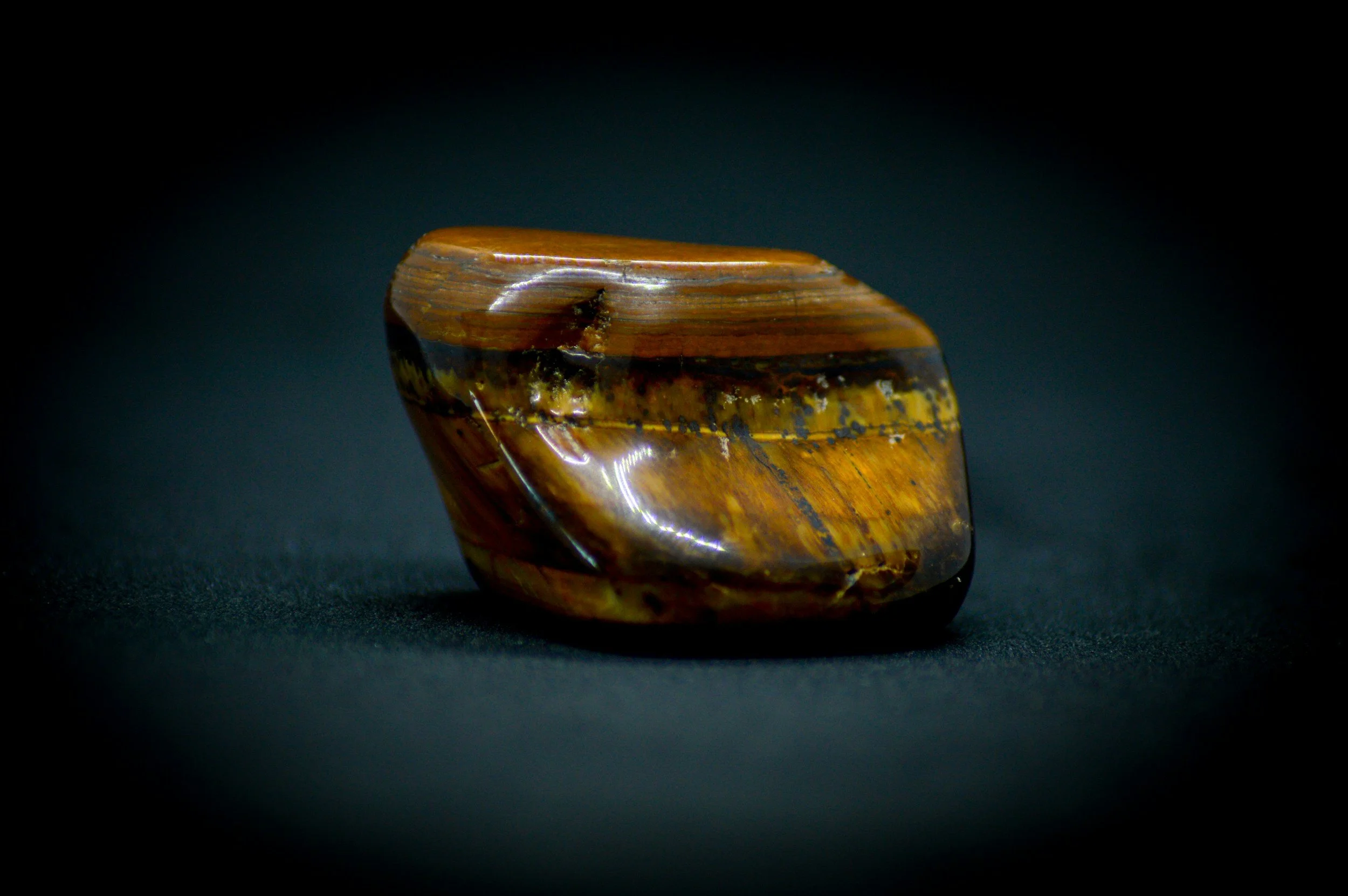 Polished Tiger's Eye crystal, traditionally associated with the Solar Plexus Chakra