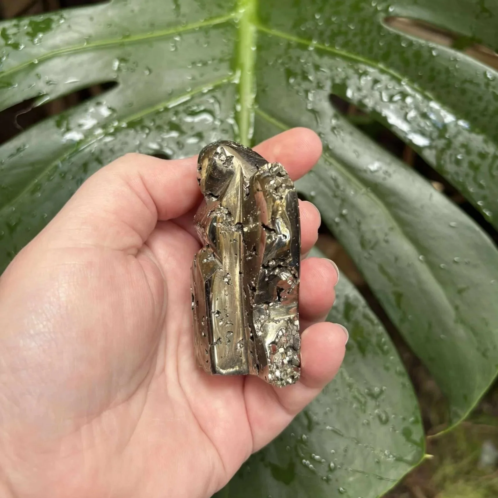 6.5cm tall Pyrite crystal carved into an angel shape, with metallic gold tones and a reflective surface.