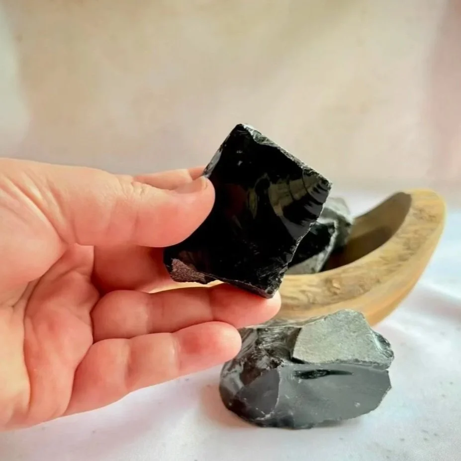 Raw Black Obsidian volcanic glass crystal with natural texture