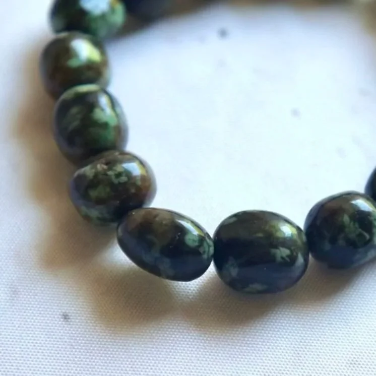 Close-up of the natural patterns and earthy colours of a Nundoorite bracelet.