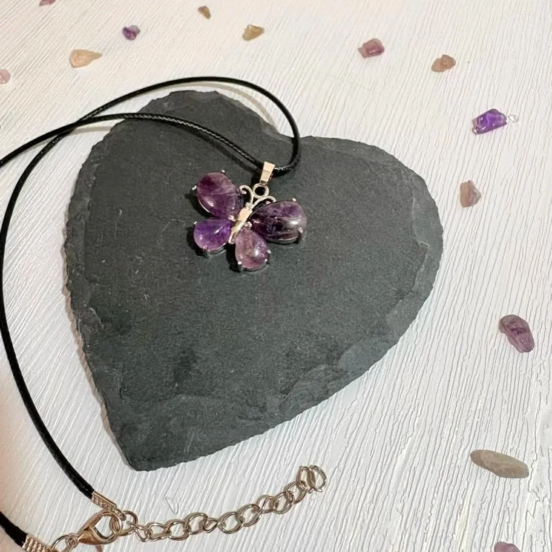 Amethyst butterfly pendant close up showing natural purple tones