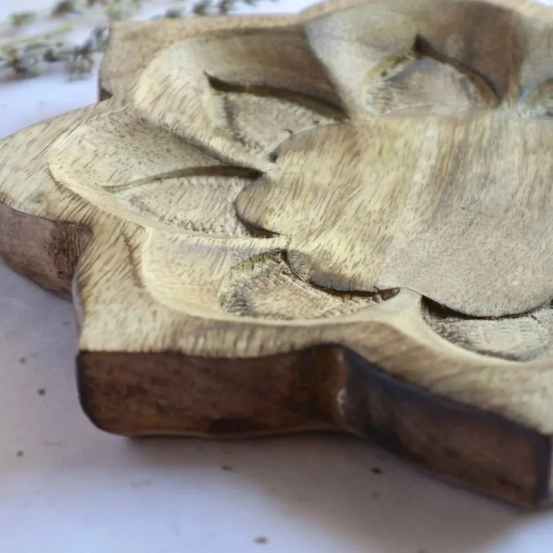 Handcrafted wooden lotus display tray with carved floral design for organising crystals and jewellery.