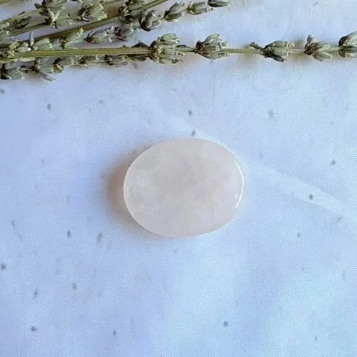 Natural Rose Quartz oval worry stone with polished finish and thumb indentation
