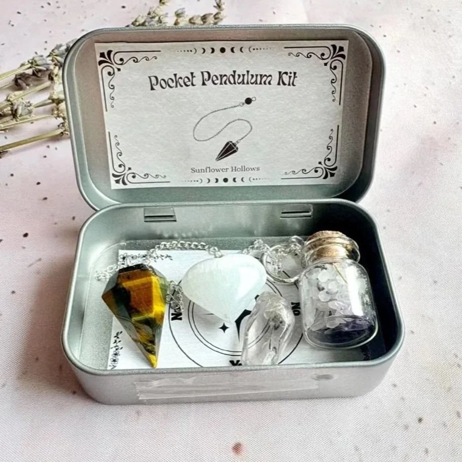 Pocket pendulum kit containing a pendulum, Satin Spar heart, and Clear Quartz tumble