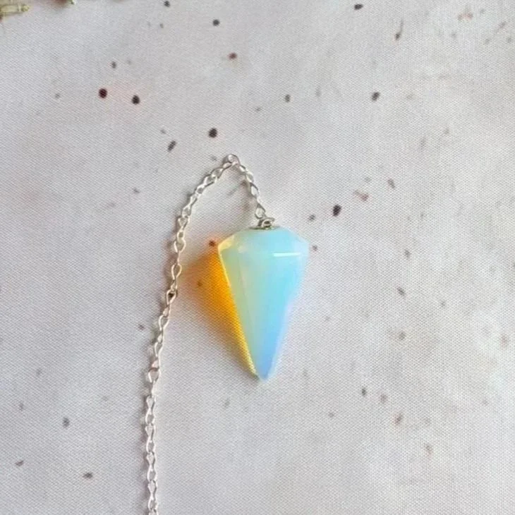 Opalite pendulum featuring a polished crystal point