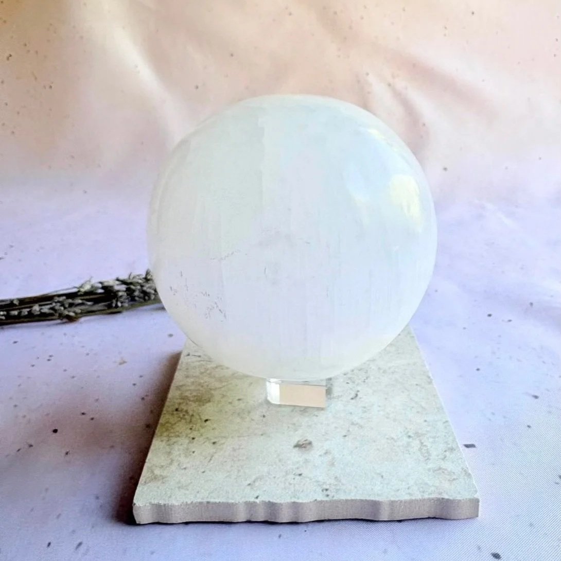 Large Satin Spar sphere displaying natural fibrous patterns and polished finish