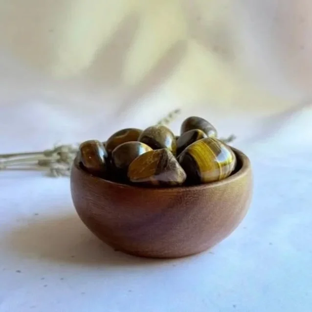 Natural Tiger's Eye tumble displaying golden brown bands and polished finish