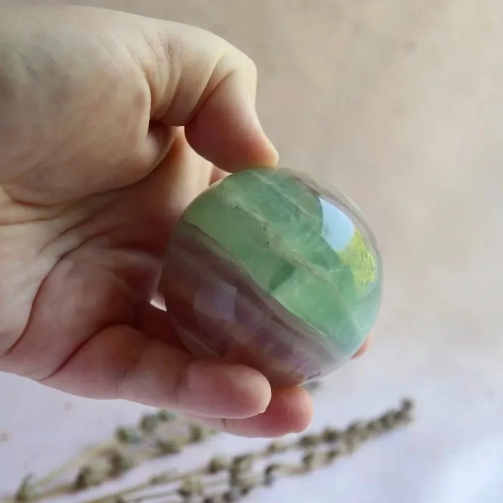 Polished Fluorite sphere with natural internal colouring and patterns
