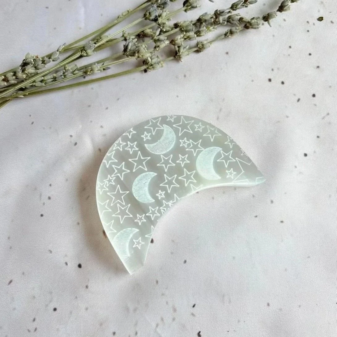 Satin Spar charging plate engraved with a moon and stars design measuring 6cm