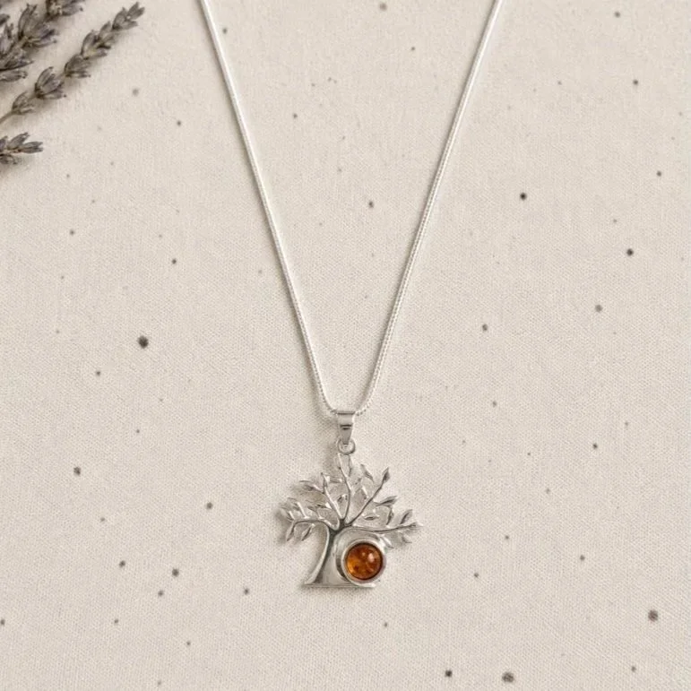 Amber Tree of Life pendant necklace displayed on neutral background