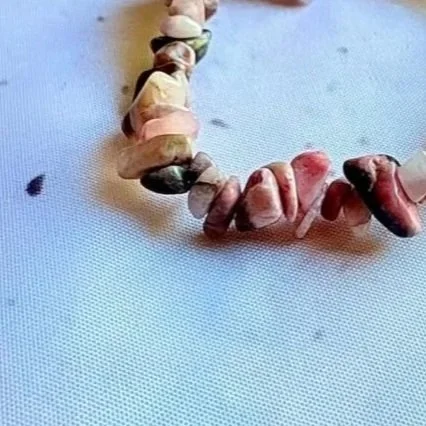 Rhodonite crystal chip bracelet featuring natural pink and black tones