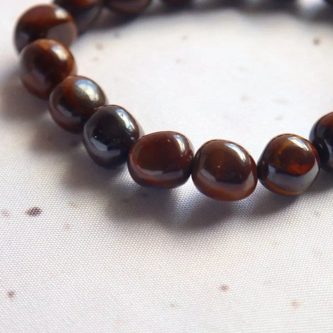 Close-up of an Australian Sunset Jasper bracelet showing the individual patterns and colours of its polished tumble beads.