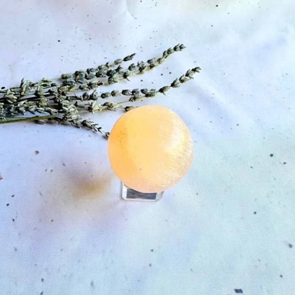 Peach Satin Spar crystal sphere displaying soft peach tones and a silky glow