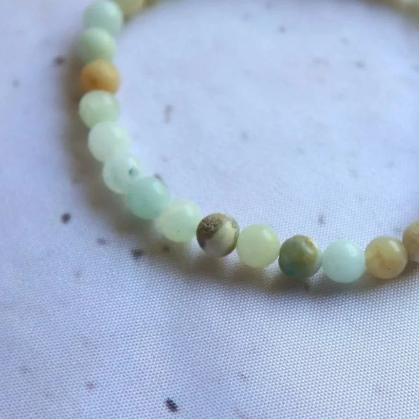 Close-up of natural green and blue tones in an Amazonite Round Bead Bracelet