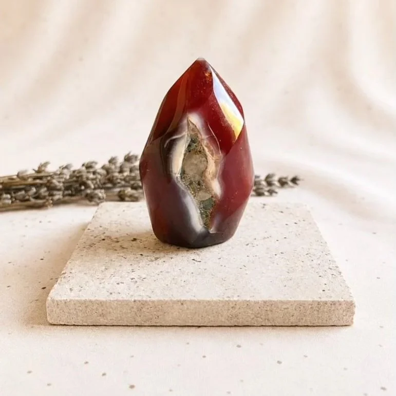 Carnelian flame carving featuring warm fiery tones and a polished finish for display