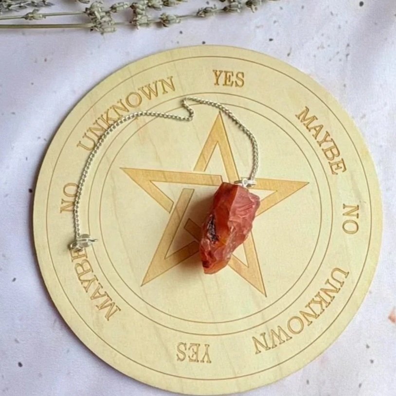 Natural Carnelian dowsing pendulum displaying vibrant orange and red tones
