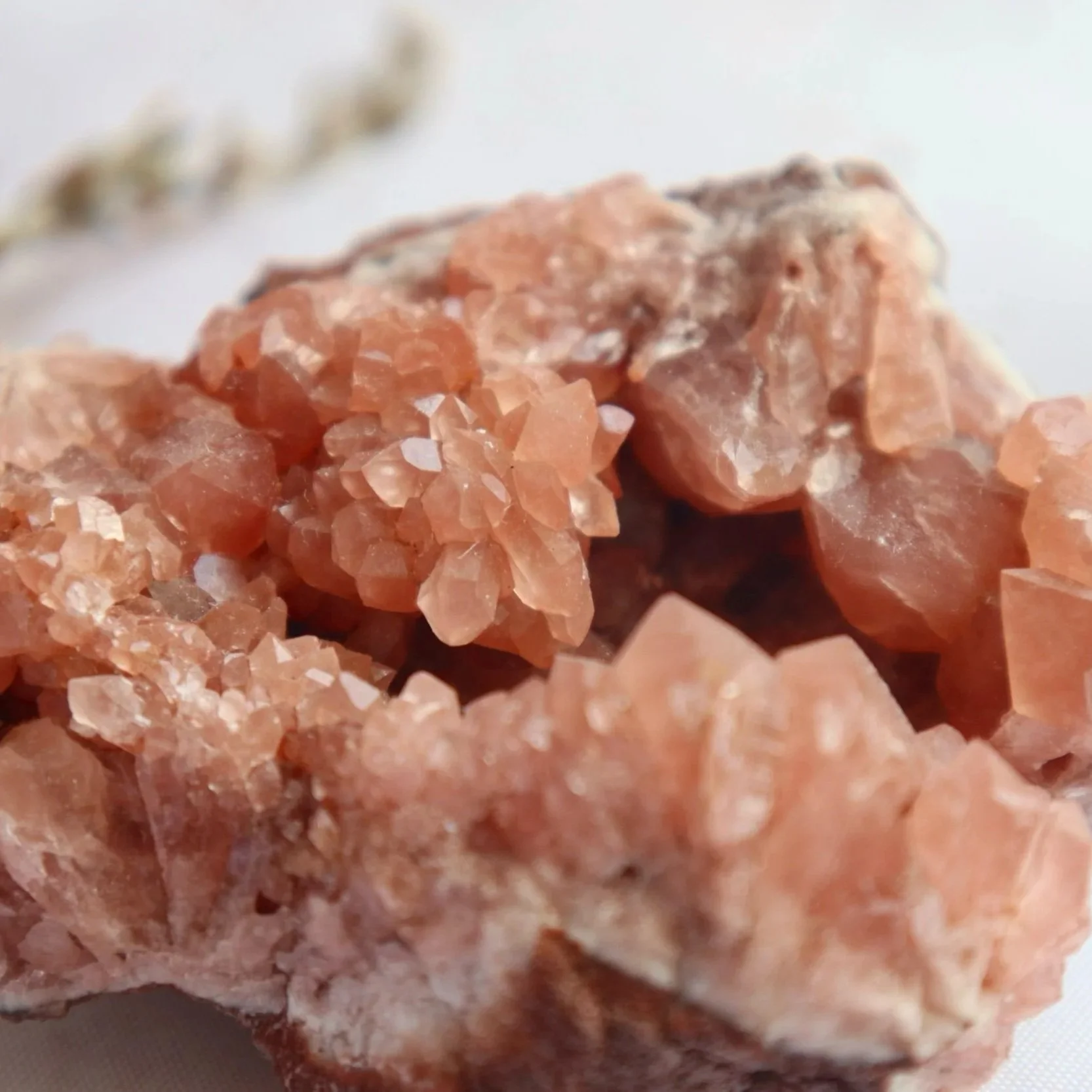 Close-up of the delicate peach-pink crystal points on a natural Pink Amethyst cluster.