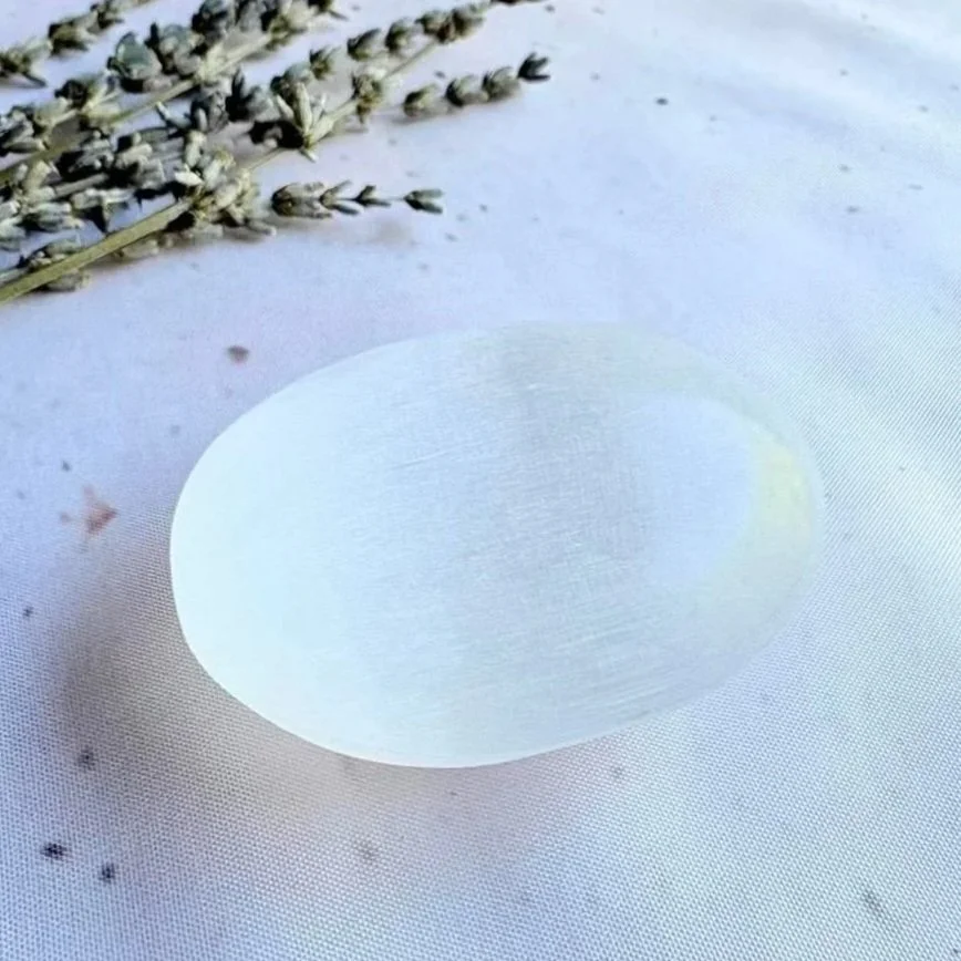 Satin Spar palm stone measuring approximately 7cm long and 6cm wide